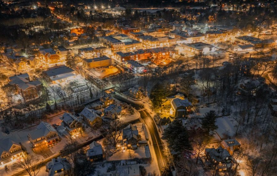 Small town glowing with holiday lights on a snowy evening (stock photo)